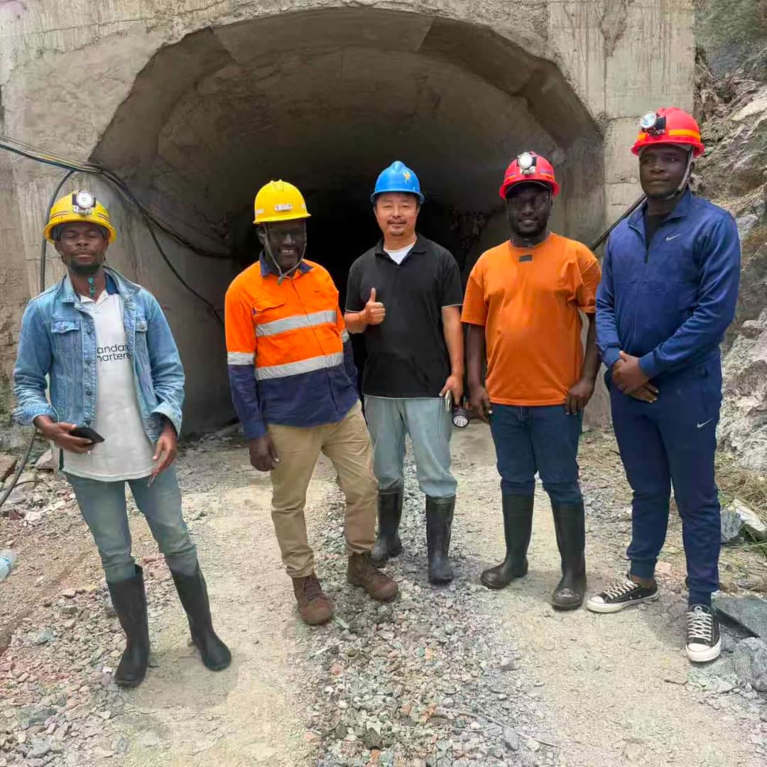 Team at mine tunnel entrance